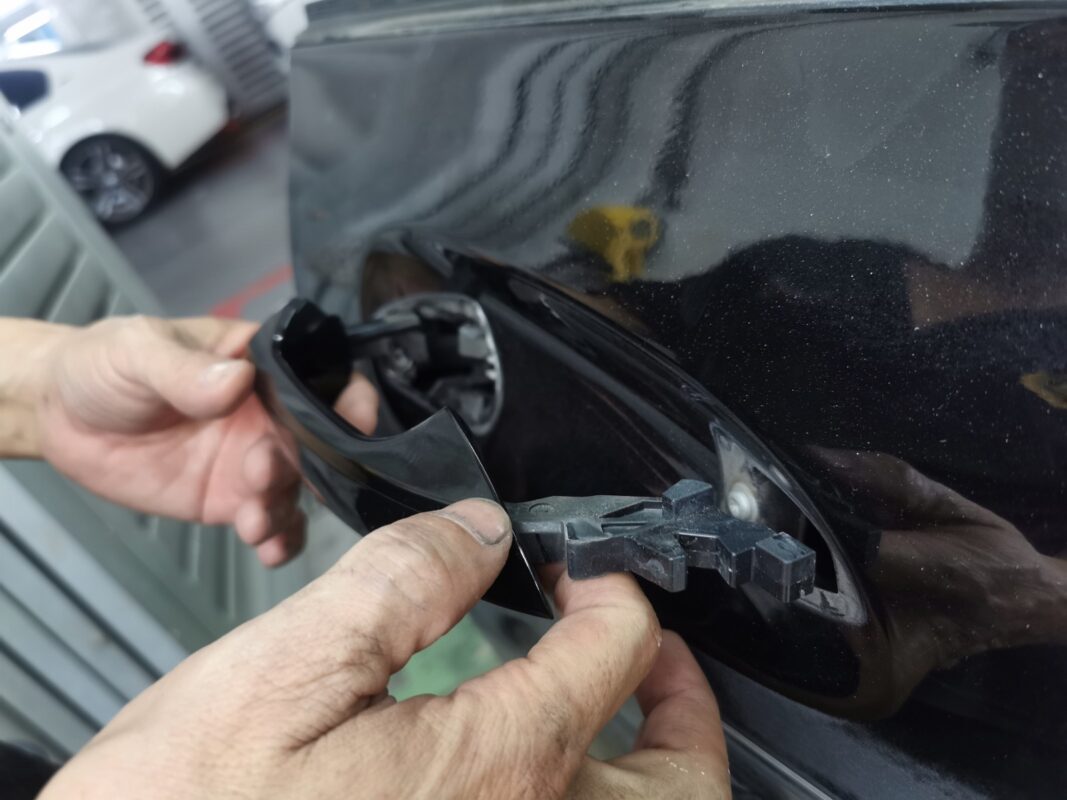 A door handle trim removed as the Mercedes-Benz CLA180 is stripped down for the respray.