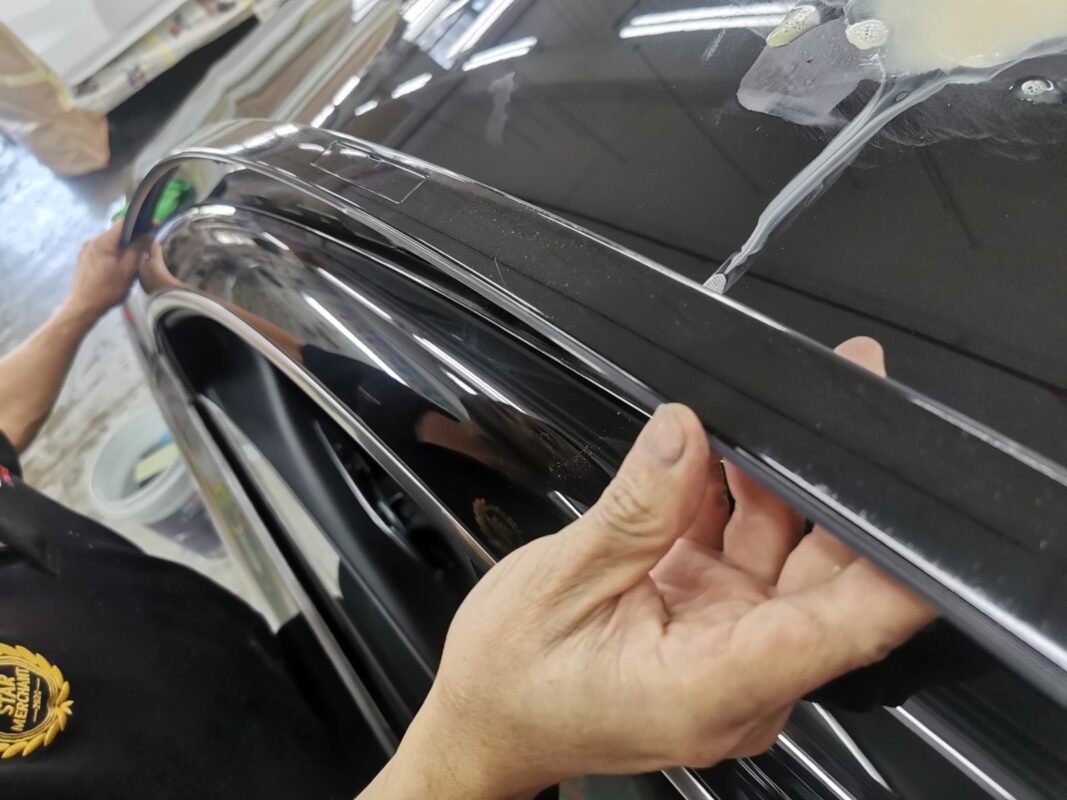 Chrome window trim removed from the Mercedes-Benz CLA180 before painting.