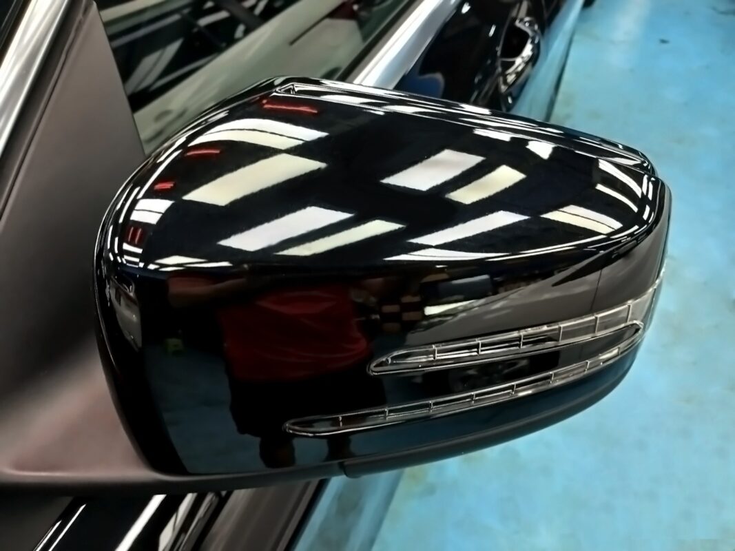 Refitting the Mercedes-Benz CLA180's mirror cap after painting.