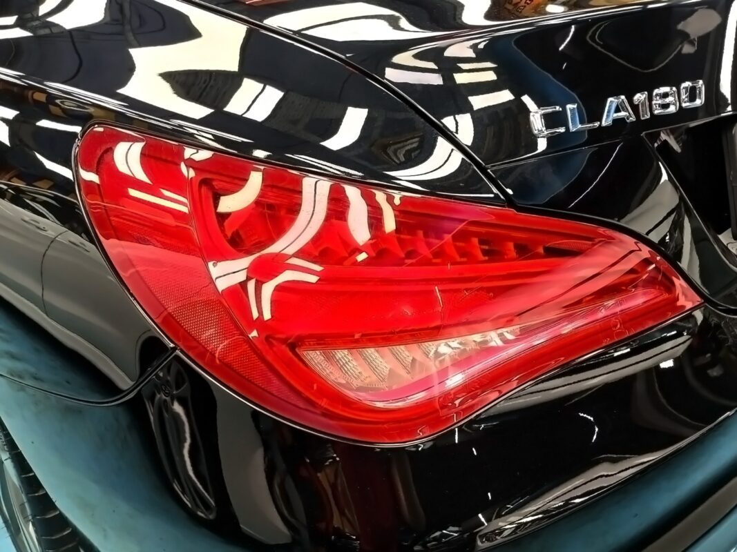 The Mercedes-Benz CLA180's tail light and rear badge, glossy after the respray.