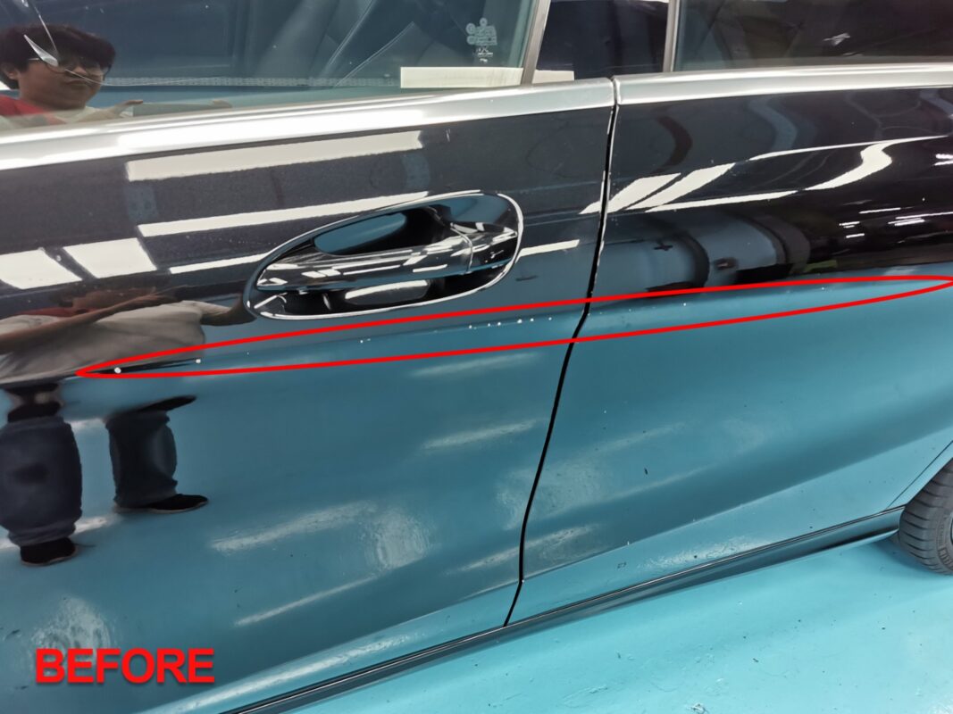 Before: a door panel of the Mercedes-Benz CLA180 marked with paint defects.