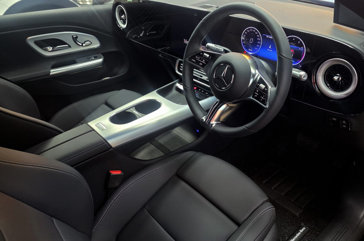 Reflections across the coated panels of the Mercedes-Benz CLA180.