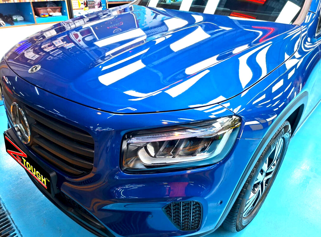 The Mercedes-Benz GLB180's coated paintwork under workshop lighting.