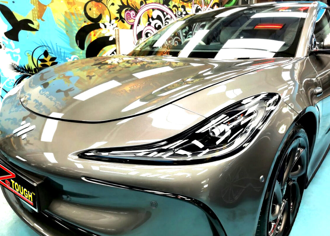 The MG IM5's coated paintwork under workshop lighting.
