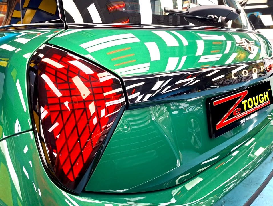 Close-up of the MINI Cooper's triangular tail lamp and tailgate with ZeTough plate.