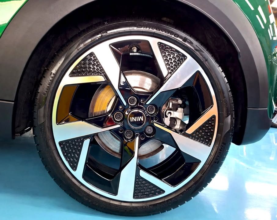 Two-tone alloy wheel on the green MINI Cooper.