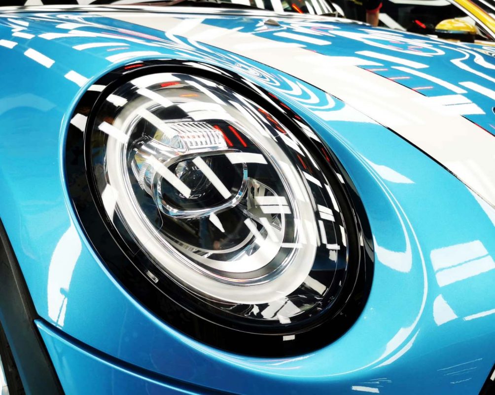 The MINI Cooper's coated paintwork showing clean reflections.