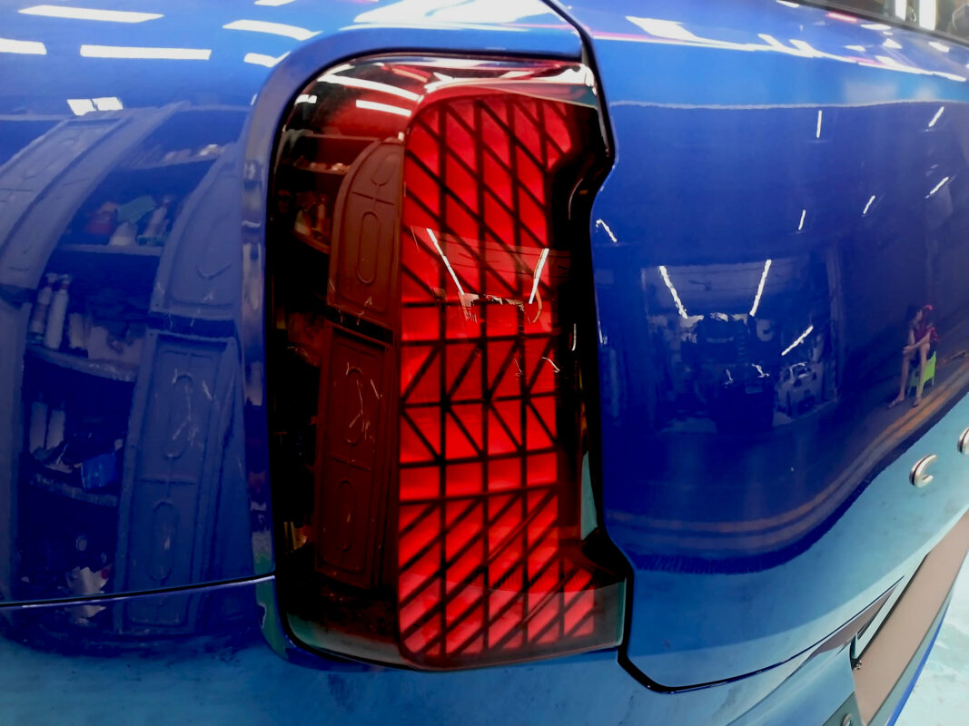 The coated bonnet of the MINI Countryman Cooper under workshop lighting.