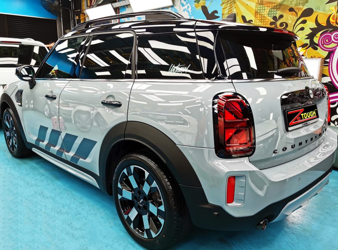 The coated bonnet of the MINI Countryman under workshop lighting.