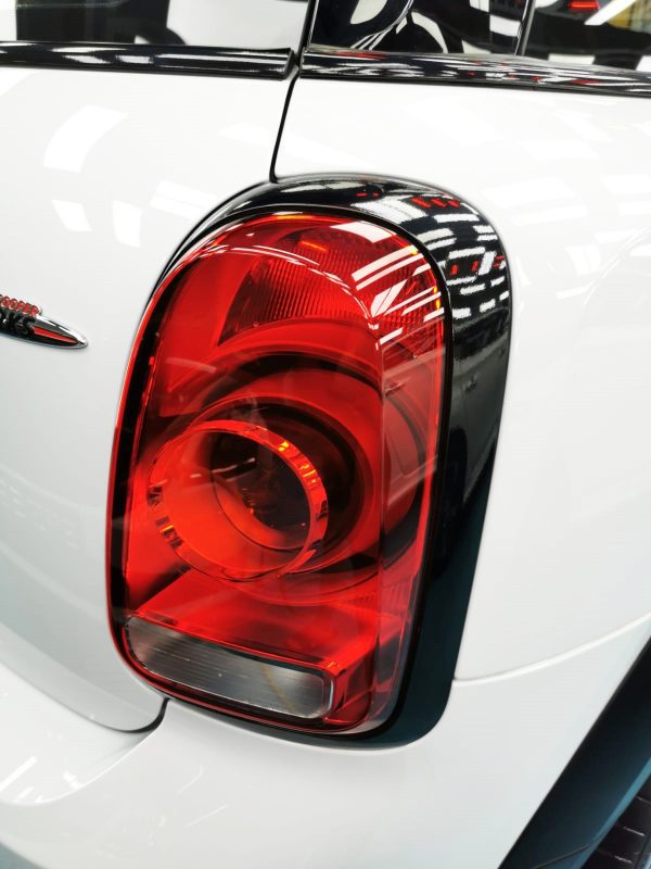 The coated bonnet of the MINI Countryman under workshop lighting.