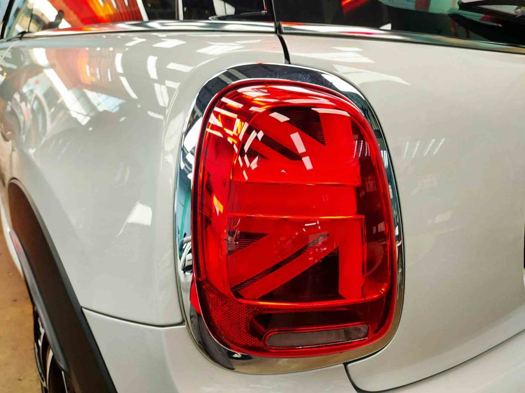 The coated bonnet of the MINI JCW under workshop lighting.