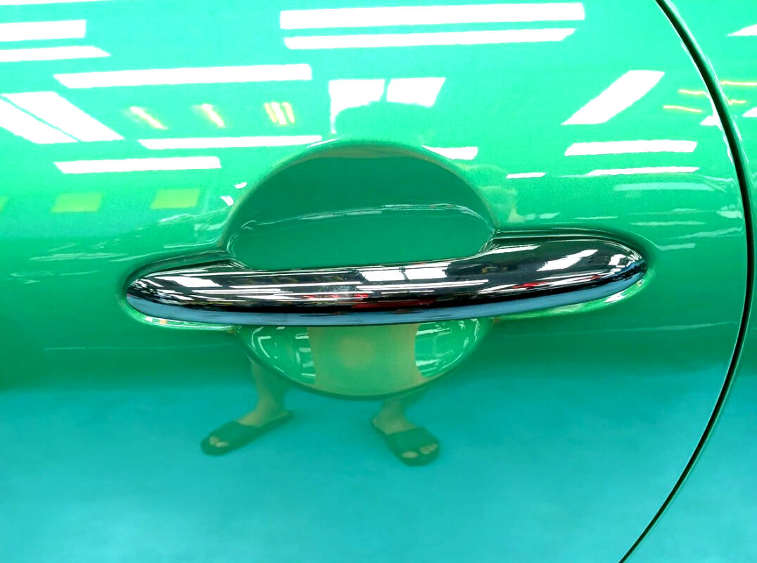 The coated bonnet of the MINI John Cooper under workshop lighting.