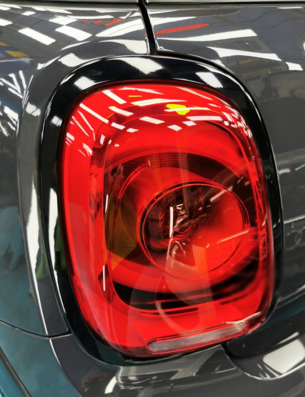 The coated bonnet of the MINI John Cooper under workshop lighting.