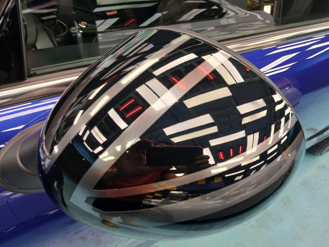 The MINI One's coated paintwork showing clean reflections.
