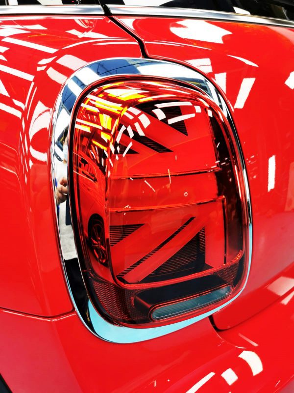 The coated bonnet of the MINI One SW under workshop lighting.
