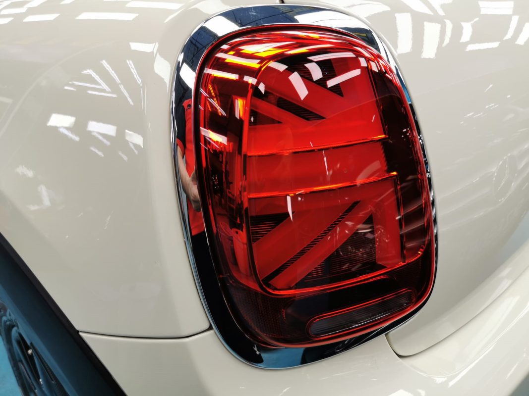 The bonnet of the MINI One under workshop lighting.