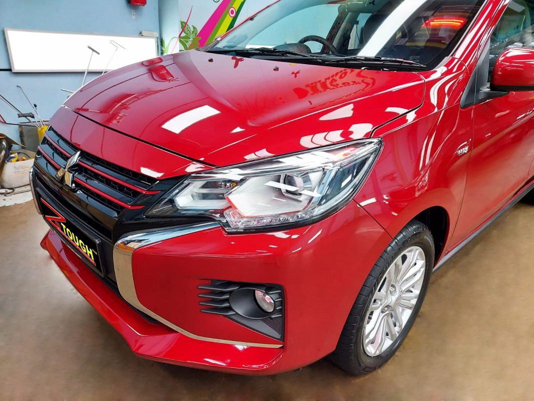 The red Mitsubishi Attrage from a side angle after the ceramic coating.