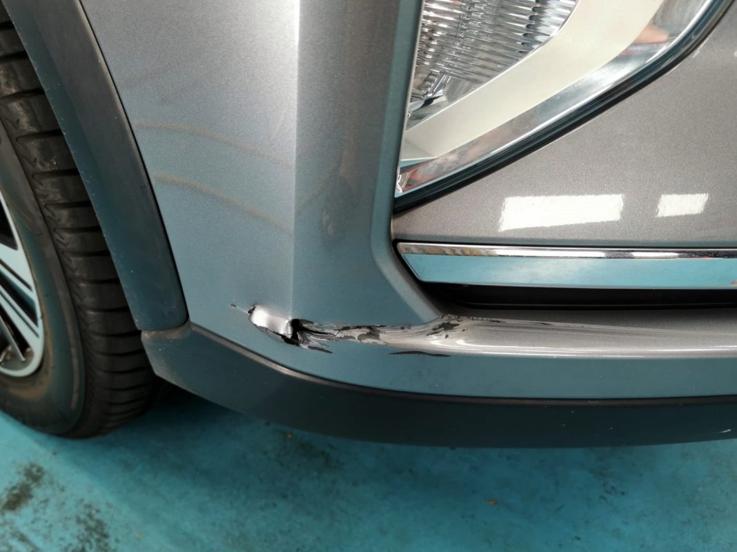 Close-up of scratches and chips on the Eclipse Cross body panels on arrival.