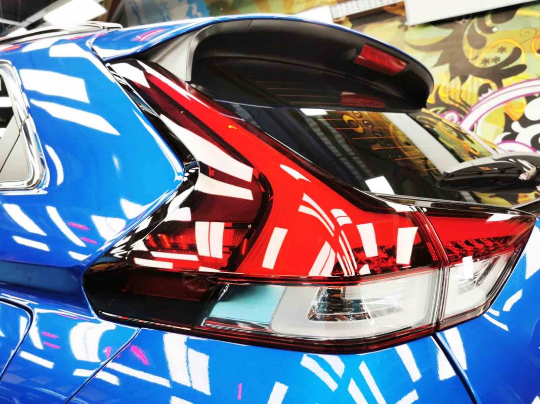 The coated bonnet of the Mitsubishi Eclipse Cross under workshop lighting.