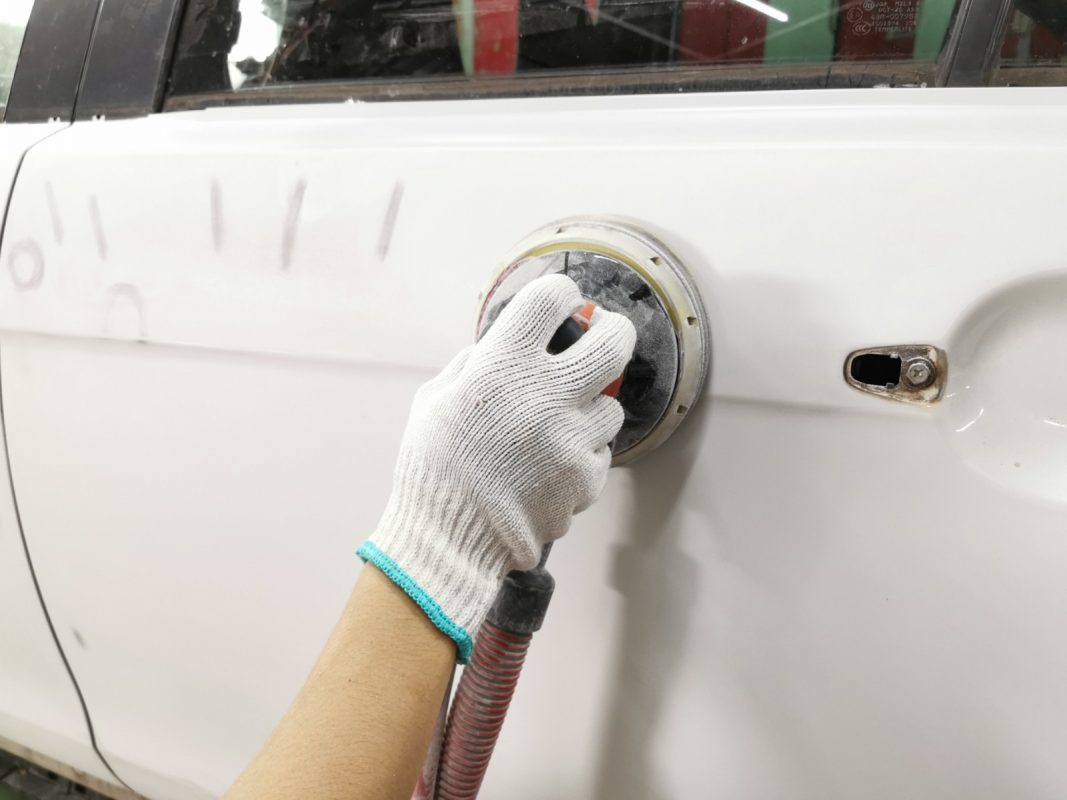 Repairing scratches and applying putty to the Evo's body.