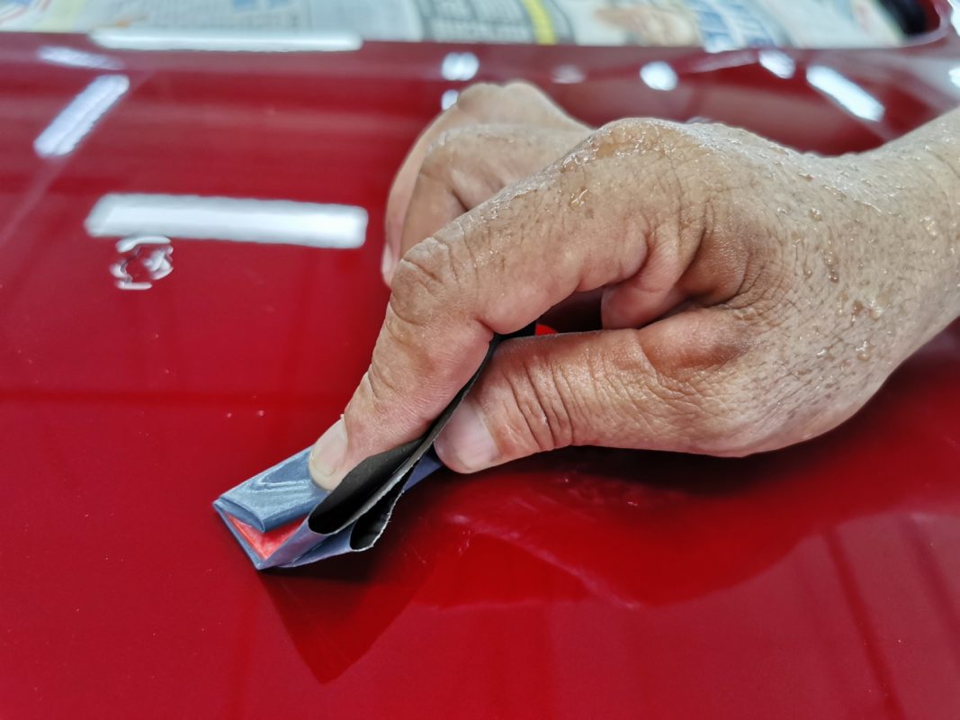 The Lancer after spraying, being wet-sanded again for an even surface.