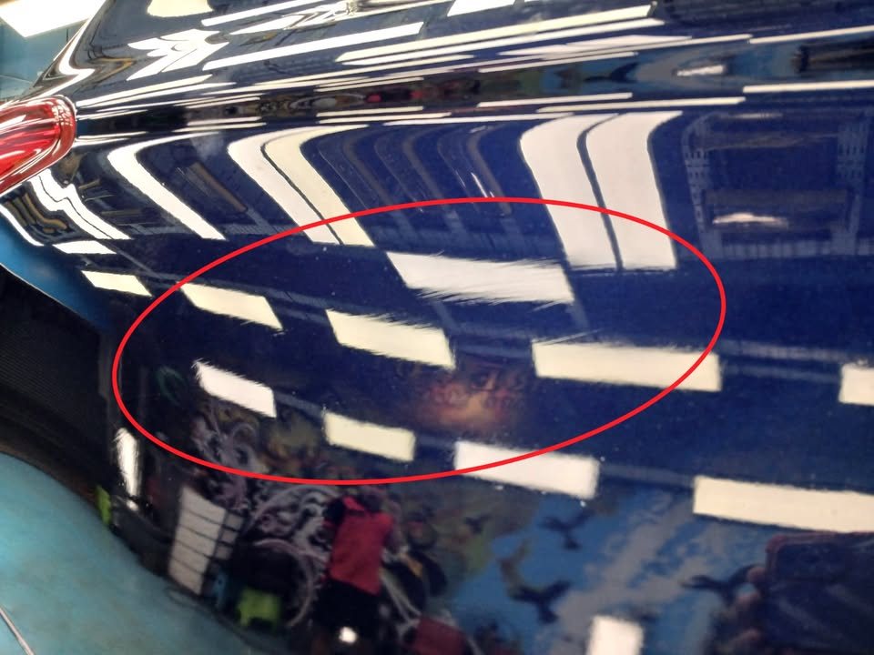 Side panel of the Outlander with dull, marked paint circled in red.