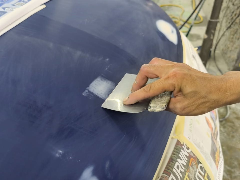 Filler spread across the Outlander's tailgate, with newspaper masking in view.