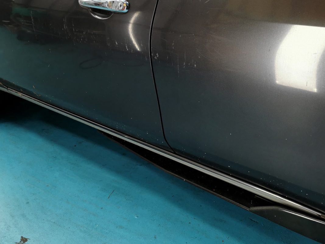 The Nissan Almera fully masked and ready for the spray booth.