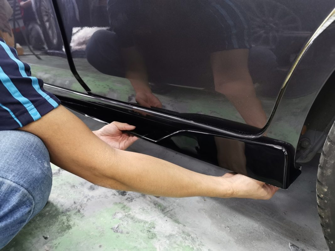 Parts being refitted onto the Nissan Almera during reassembly.