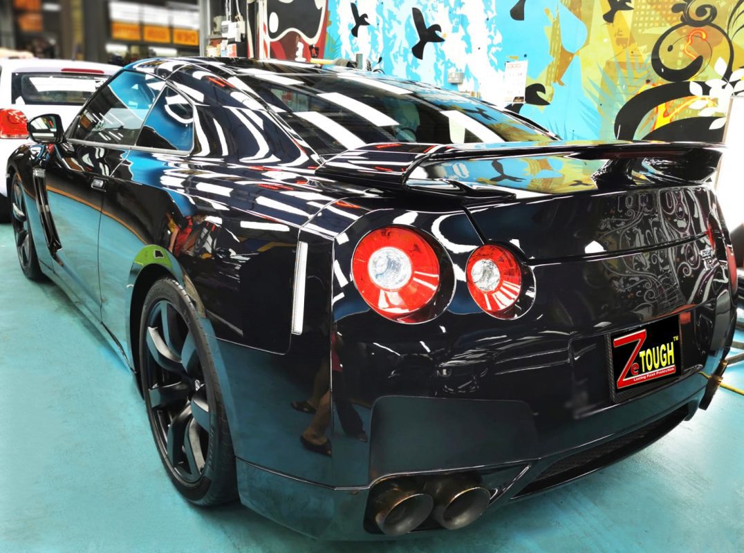 Rear quarter of the Nissan GT-R, glossy and protected.
