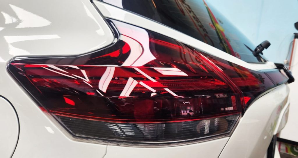 The coated bonnet of the Nissan Kicks under workshop lighting.