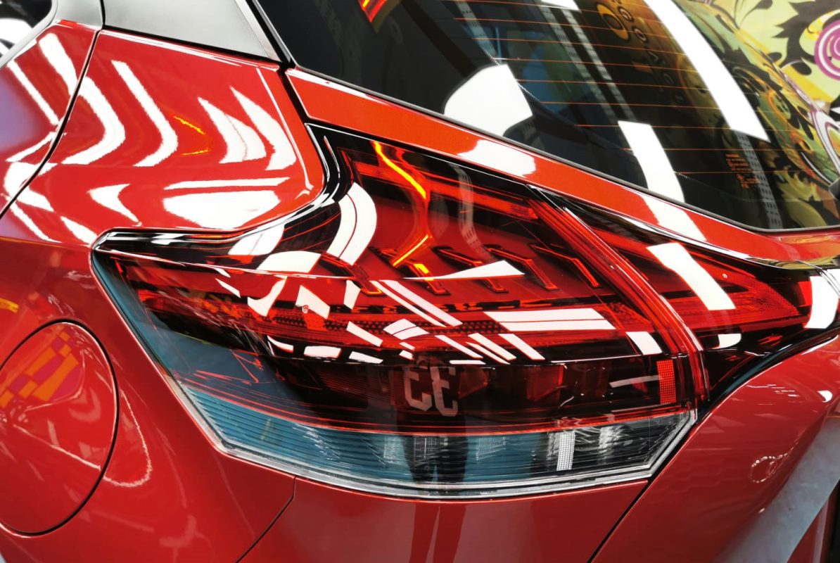 The coated bonnet of the Nissan Kicks under workshop lighting.