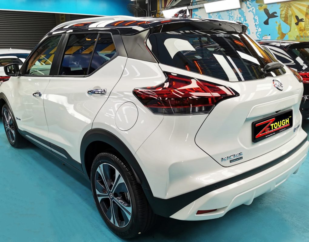 The coated bonnet of the Nissan Kicks under workshop lighting.