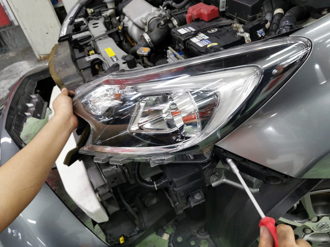 Necessary parts being removed from the Note before spraying.