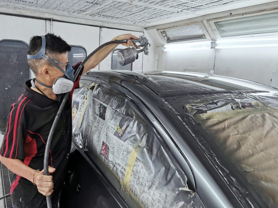 A Revol Carz painter spraying the Nissan Note in the spray booth.
