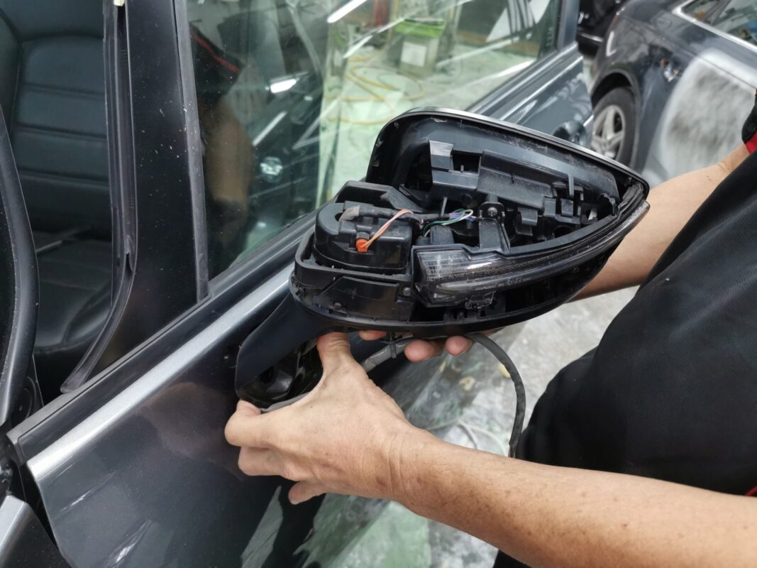 Spray painting in progress on a panel of the Nissan Note.