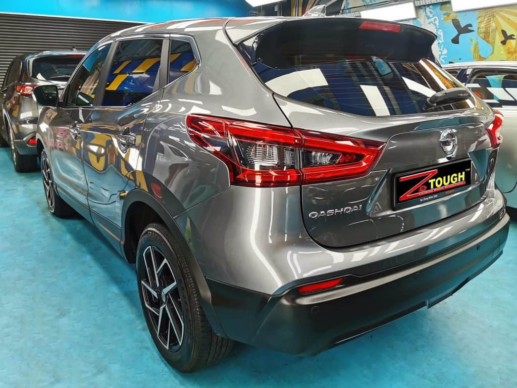 The coated bonnet of the Qashqai under workshop lighting.