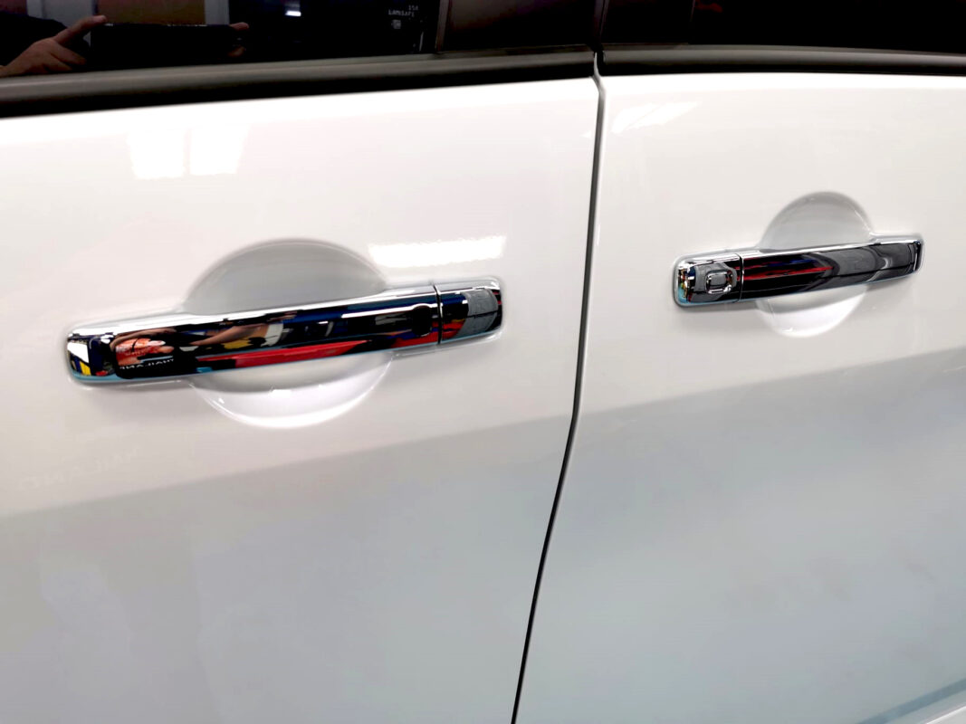 The coated bonnet of the Nissan Serena under workshop lighting.