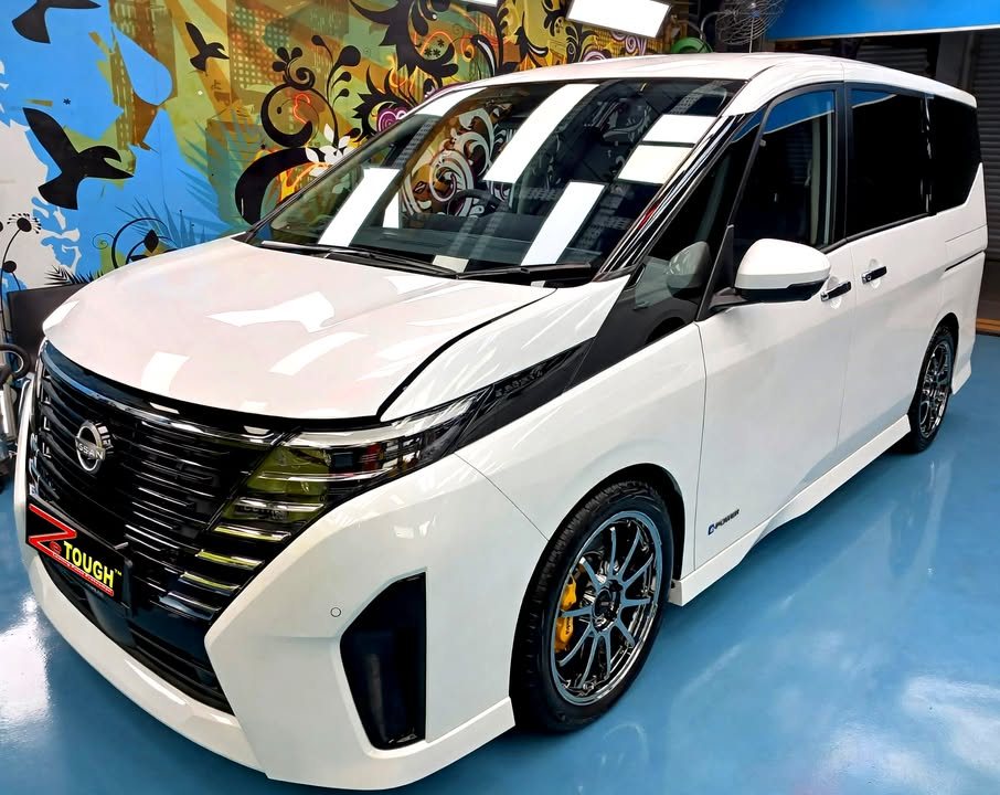 White Nissan Serena, front three-quarter view, in the Revol Carz Makeover workshop after its ZeTough Ceramic coating.