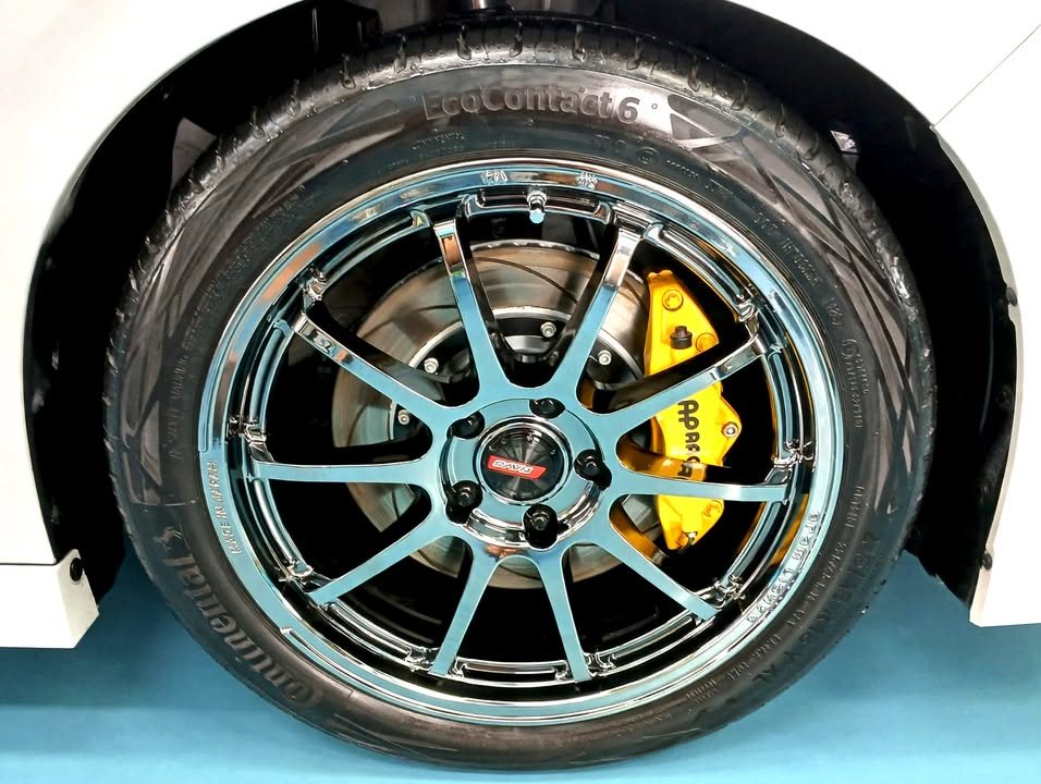 Close-up of the multi-spoke alloy wheel with yellow brake caliper.