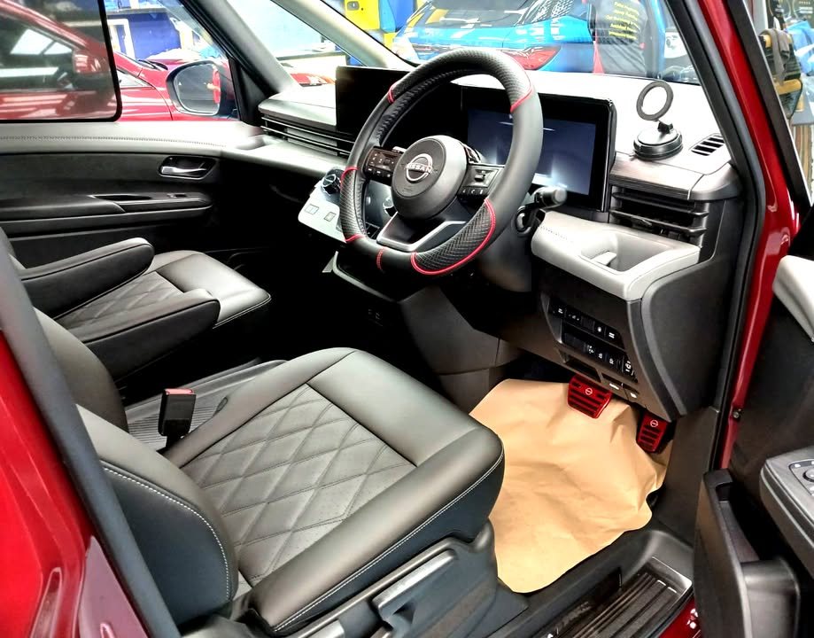 Serena driver's seat, steering wheel and dashboard after interior grooming.