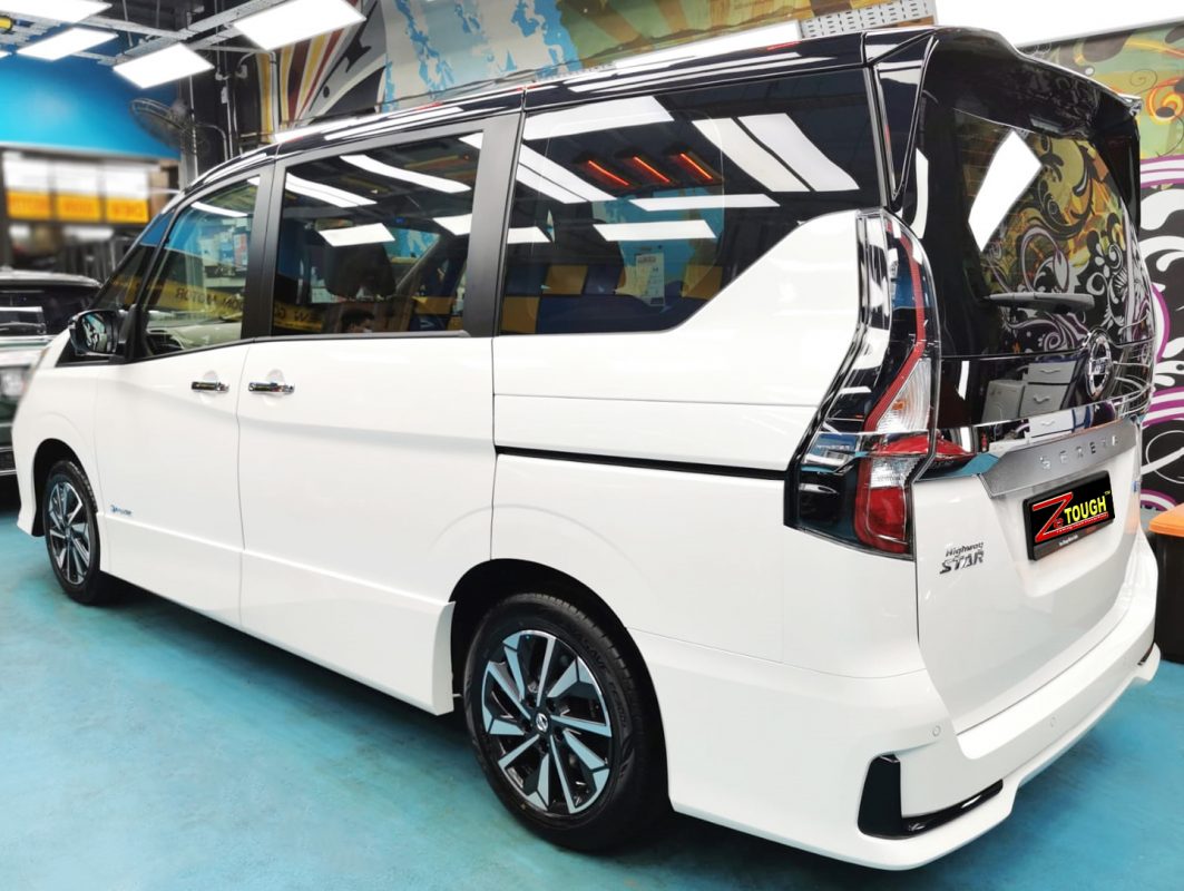 The coated bonnet of the Nissan Serena under workshop lighting.