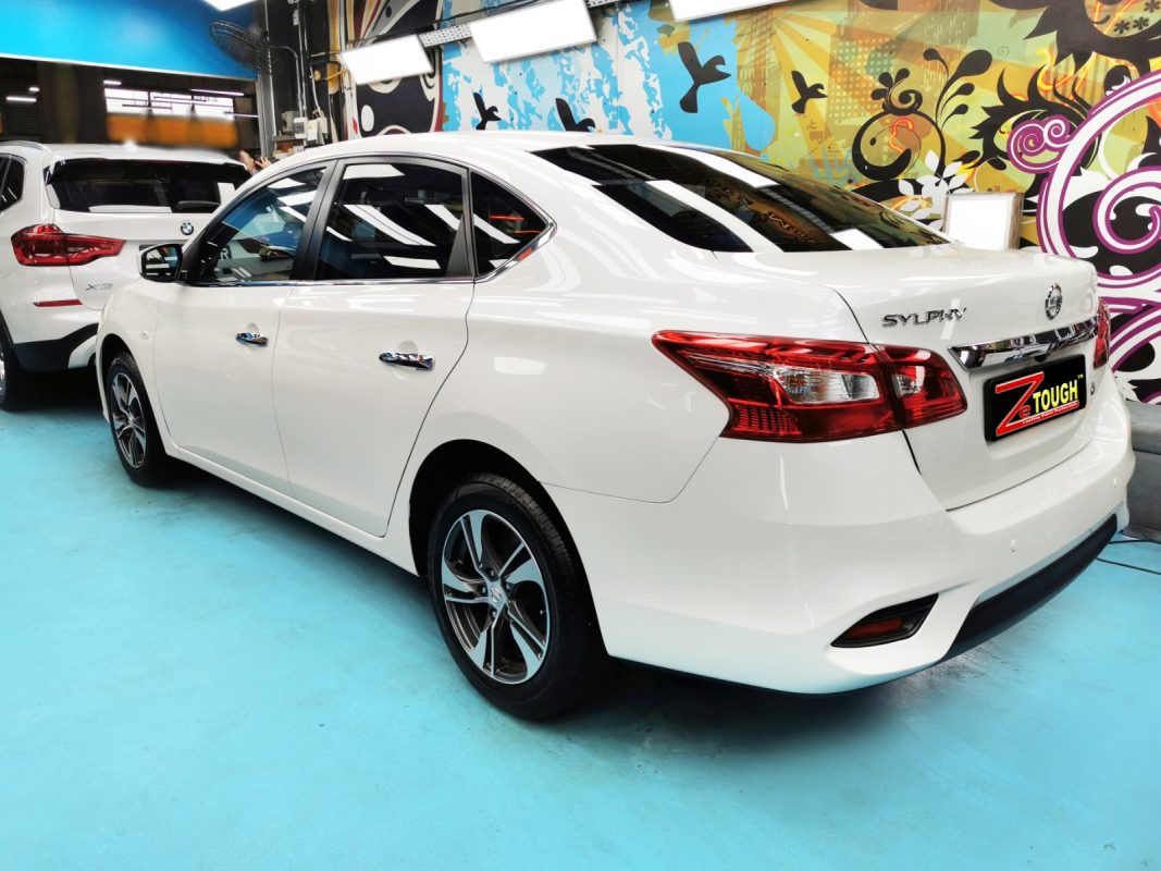 The coated bonnet of the Nissan Sylphy under workshop lighting.