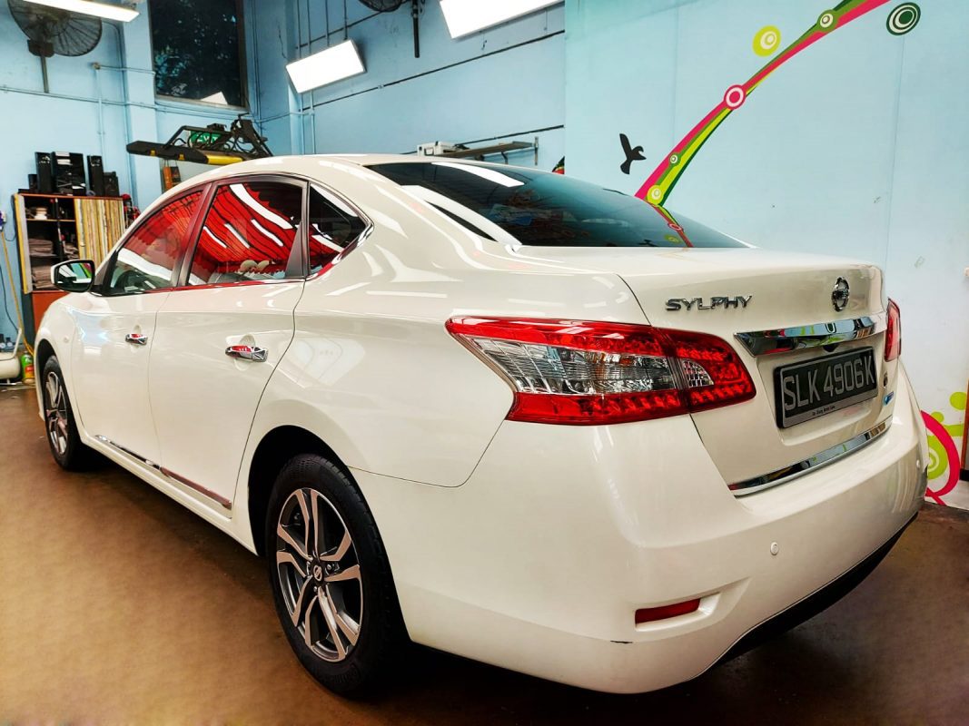 The coated bonnet of the Sylphy under workshop lighting.