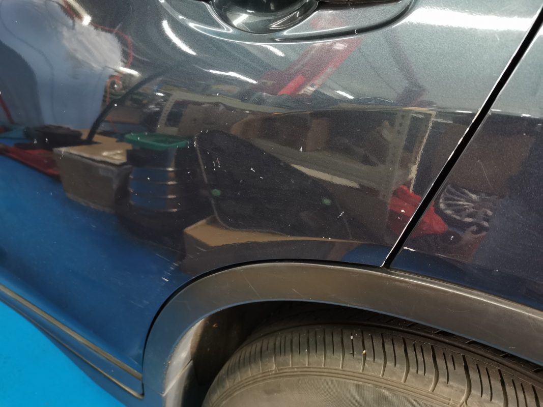 Tired paintwork on the Nissan X-Trail at intake.