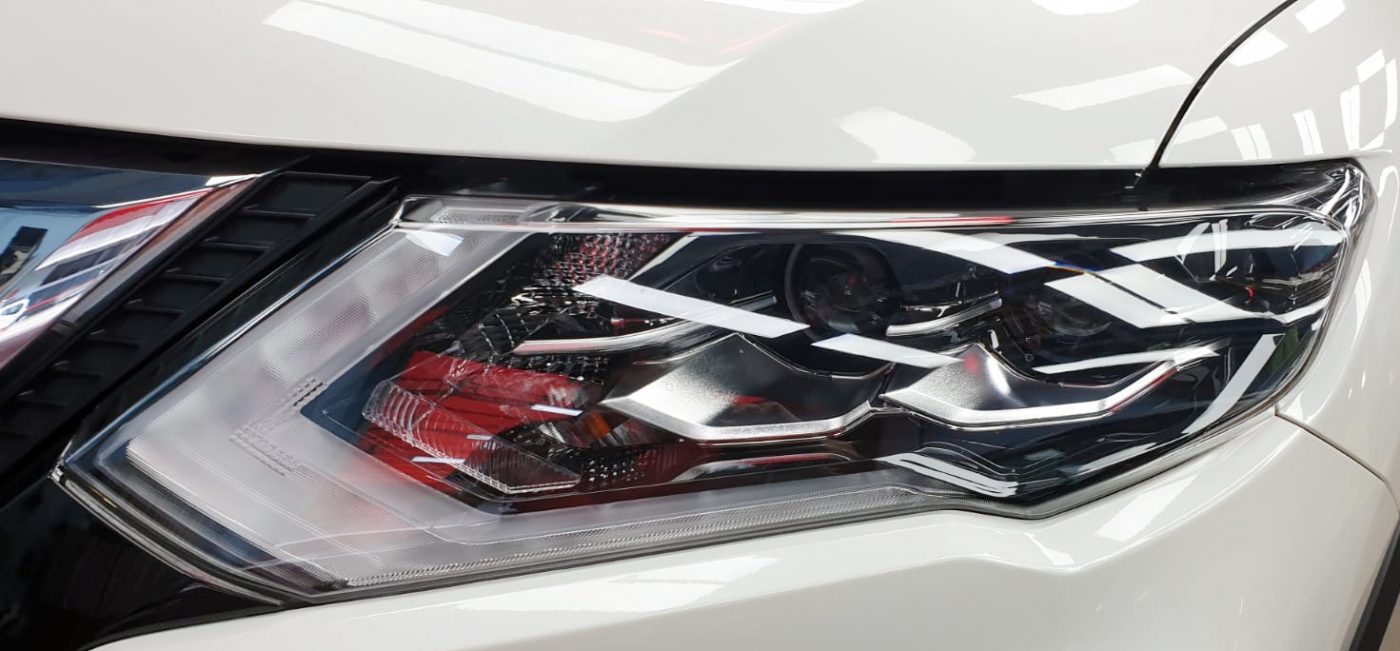 The X-Trail's coated paintwork showing clean reflections.