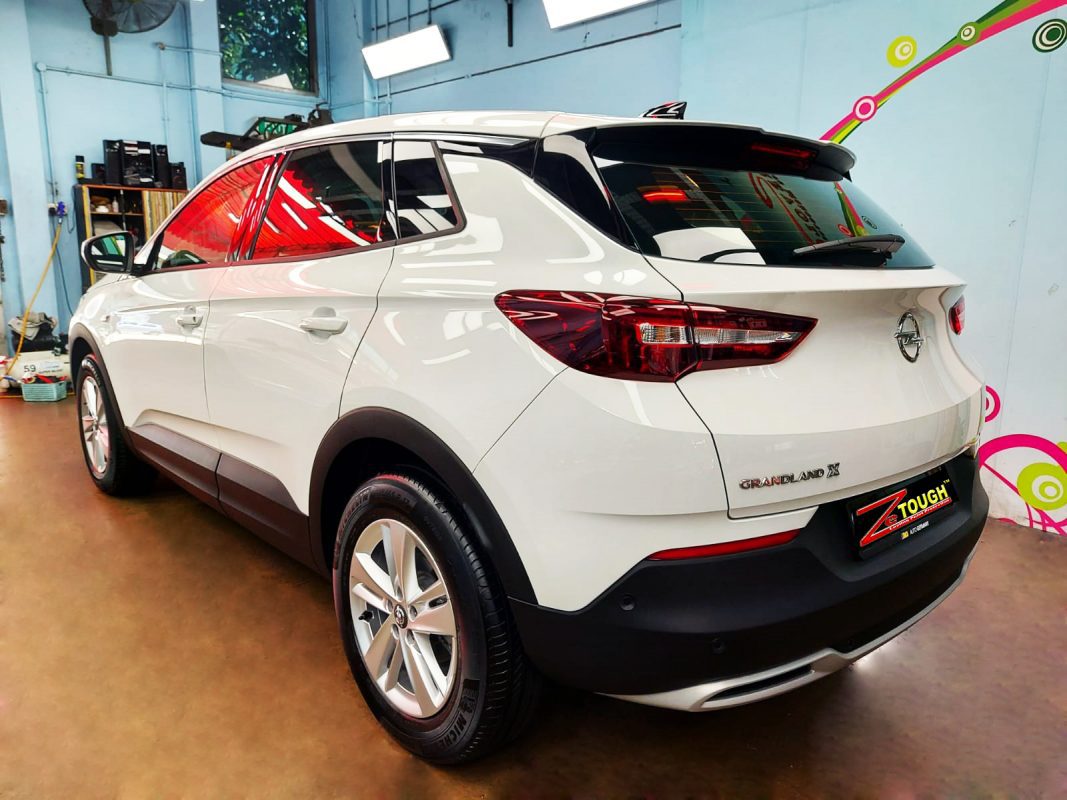 The coated bonnet of the Grandland X under workshop lighting.