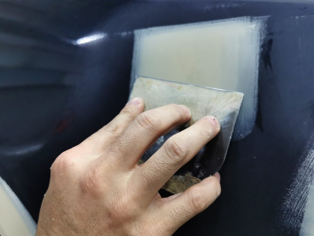 The car's surface inspected and puttied where the paintwork was imperfect.