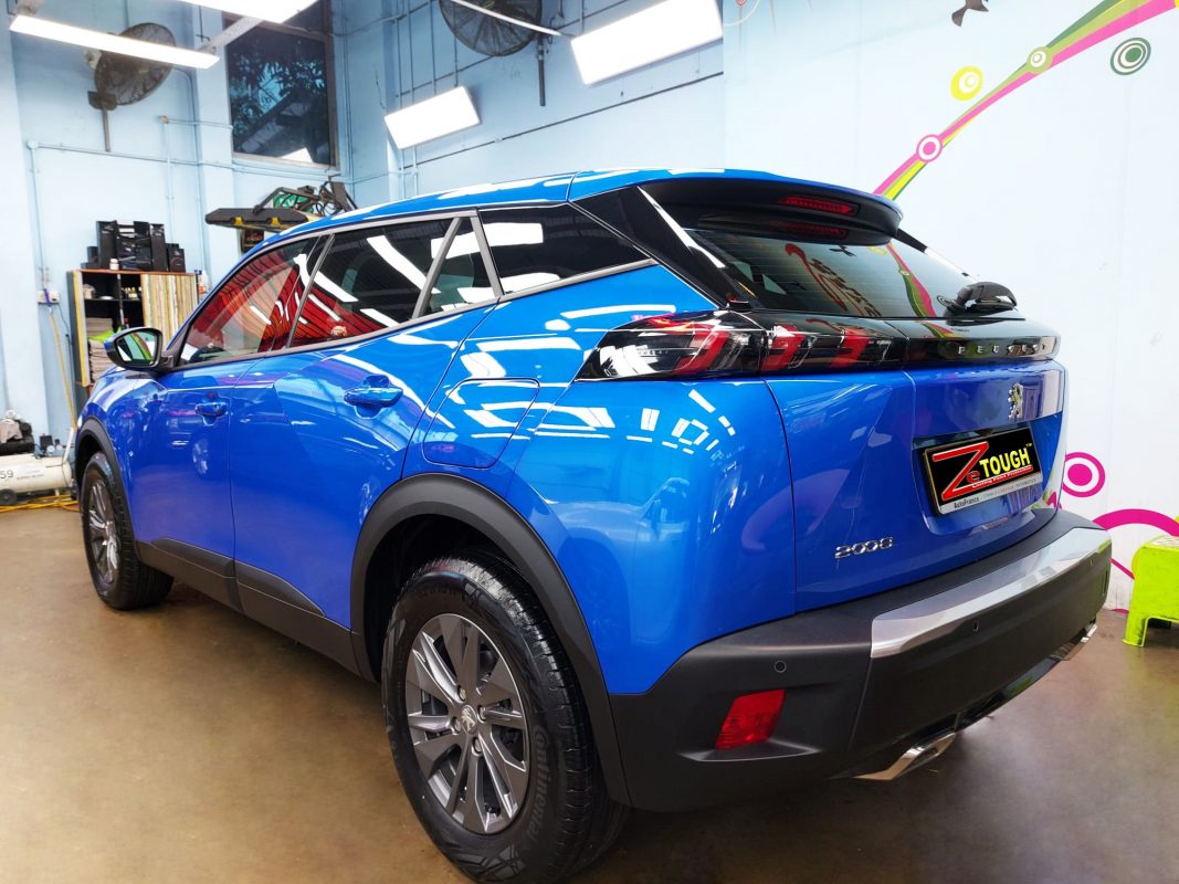 The coated bonnet of the Peugeot 2008 under workshop lighting.