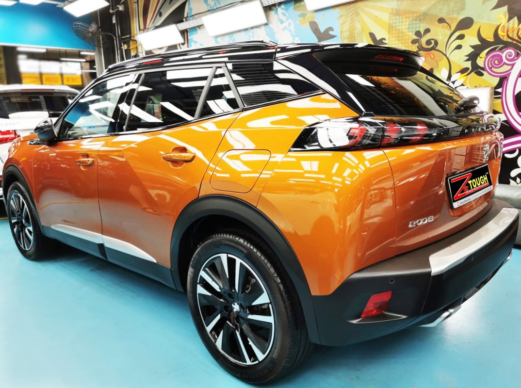The coated bonnet of the Peugeot 2008 under workshop lighting.